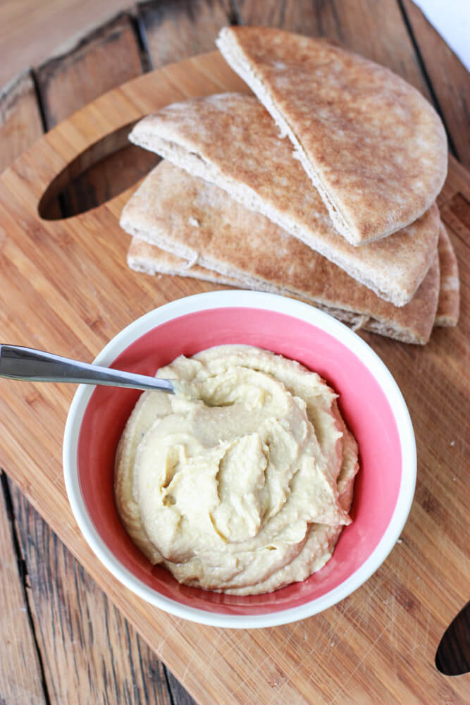 pita pockets and hummus in a bowl.