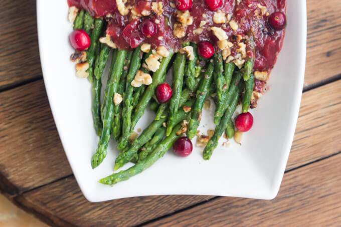 Festive holiday side dish that combines cranberry sauce with honey vinaigrette and asparagus. Super healthy, easy, and quick. | littlebroken.com @littlebroken #thanksgiving #sidedish #asparagus