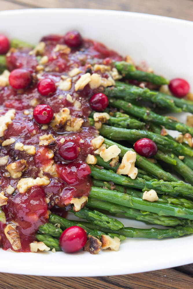 Festive holiday side dish that combines cranberry sauce with honey vinaigrette and asparagus. Super healthy, easy, and quick. | littlebroken.com @littlebroken #thanksgiving #sidedish #asparagus