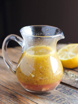 Greek salad dressing in glass container.