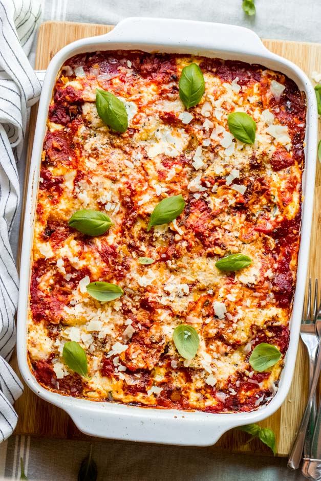 ina garten lasagna with basil in a baking dish.