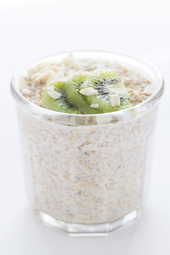 overnight oats with kiwi in glass container.