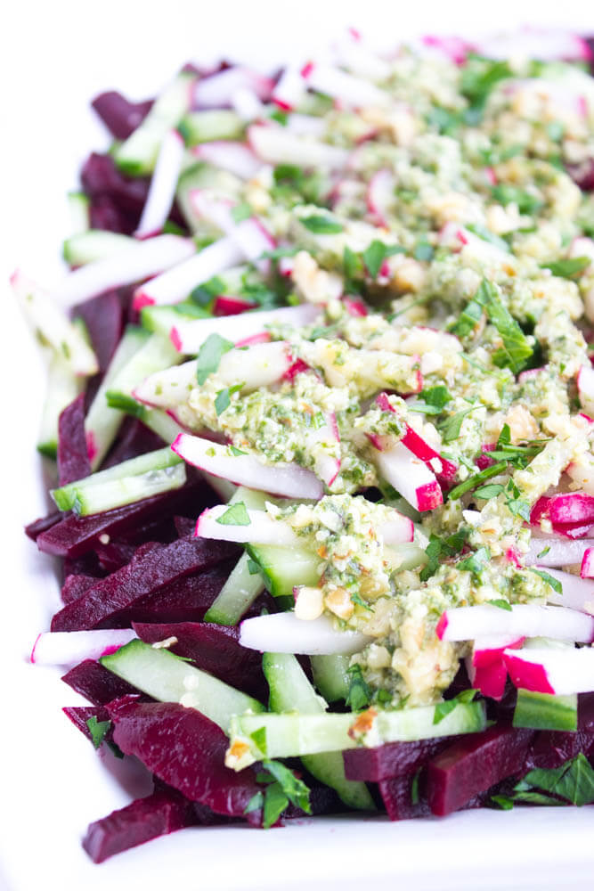 Simple and easy vegetable salad with beets, cucumbers, and radishes, tossed in a crunchy basil pesto vinaigrette | littlebroken.com @littlebroken