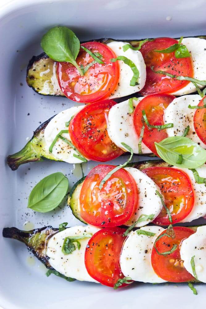 grilled zucchini topped with tomatoes and mozzarella