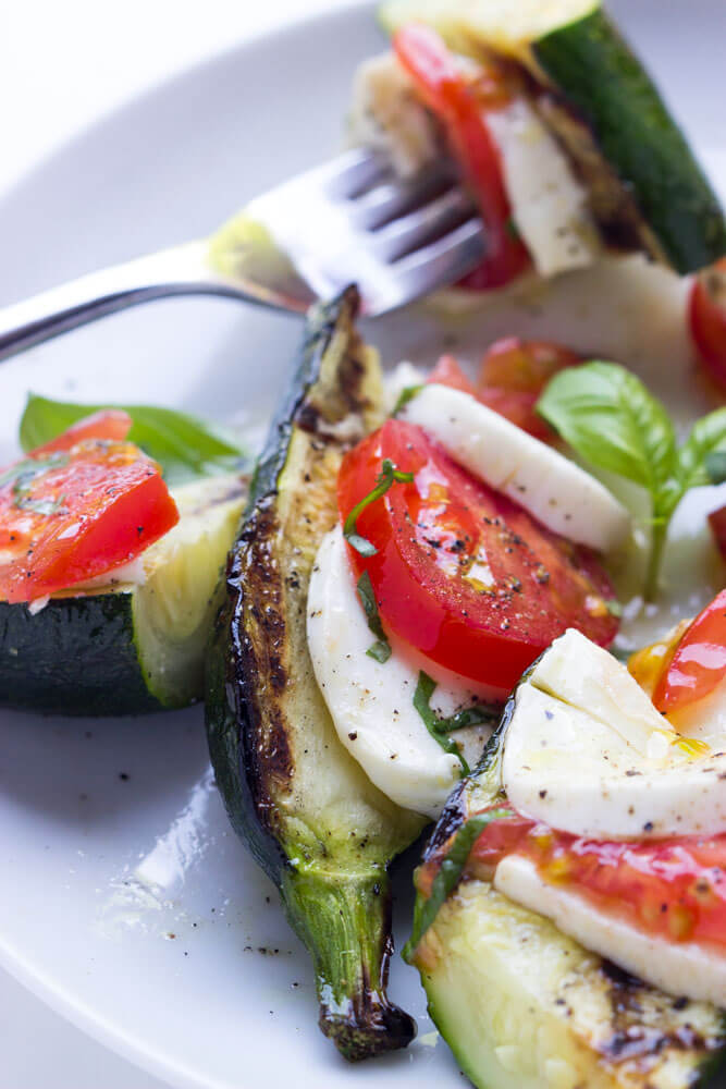 Such an easy summer side! Grilled zucchini topped with caprese: tomatoes, fresh mozzarella, and basil | littlebroken.com @littlebroken
