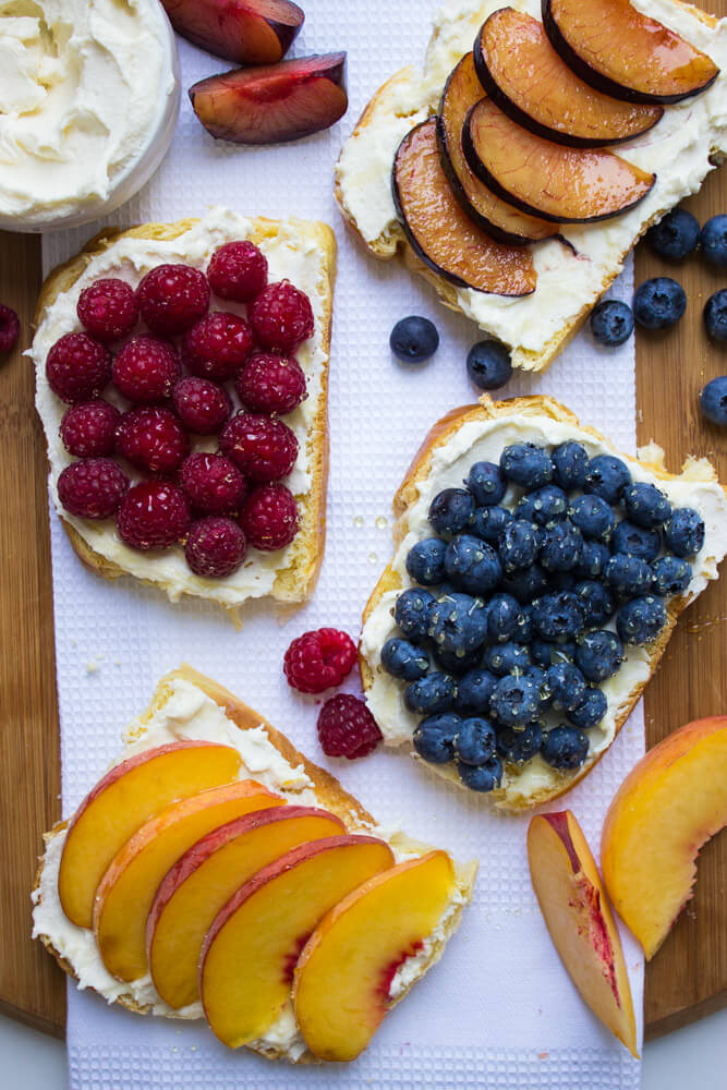 fruit toast topped with fresh fruit and drizzle of honey.