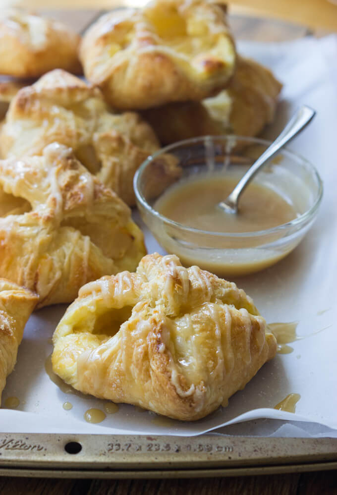 Apple Cheese Danishes with Caramel Glaze - flaky, buttery double cheese danishes with tart apples and simple caramel glaze. With just few simple ingredients you can make these at home! | littlebroken.com @littlebroken