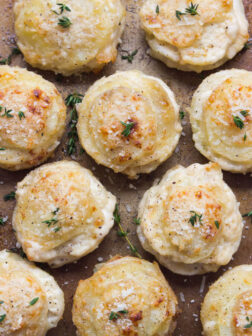 Creamy Potato Stacks with Garlic, Thyme and Parmesan - made in a standard muffin pan, these potato stacks are creamy on the inside and crispy on the outside. Super delicious side for any dinner party! | littlebroken.com @littlebroken