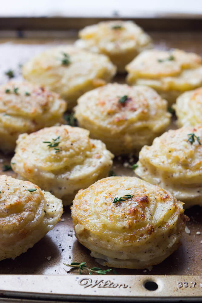 Creamy Potato Stacks with Garlic, Thyme and Parmesan - made in a standard muffin pan, these potato stacks are creamy on the inside and crispy on the outside. Super delicious side for any dinner party! | littlebroken.com @littlebroken