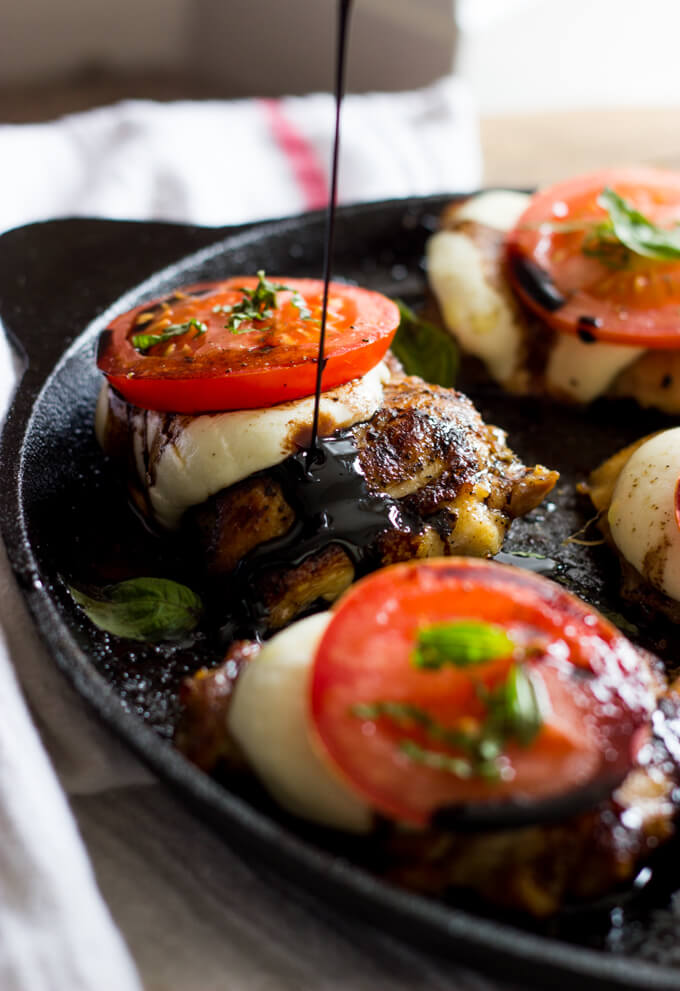 Side view of balsamic glaze over caprese mozzarella chicken.