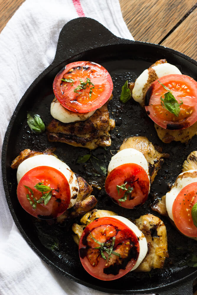 Overhead chicken caprese recipe in skillet.