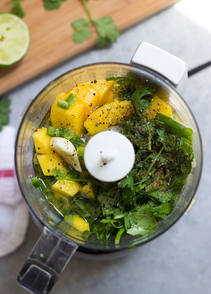 ingredients in a food processor for mango cilantro dressing