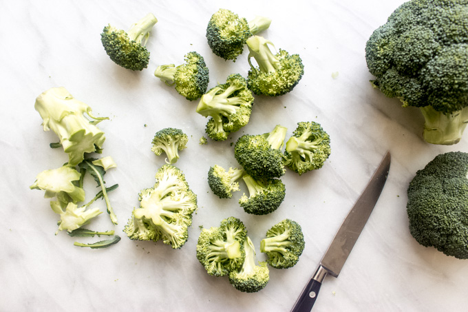 Chopped raw broccoli on white board