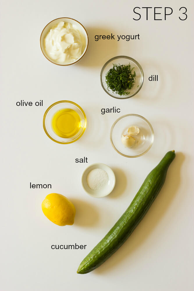 Ingredients for tzatziki sauce on white board