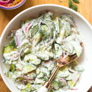 Greek Cucumber Salad - made with marinated onions and creamy Greek yogurt dressing. This simple summer side is insanely delicious and easy to make! | littlebroken.com @littlebroken