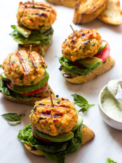 side view of salmon burgers on baguette slice