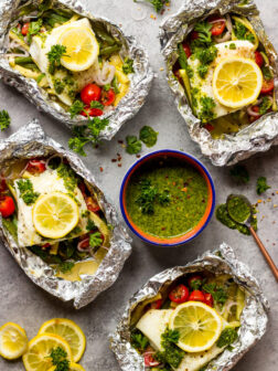 Baked Fish and Vegetables in Foil with Chimichurri Sauce - white fish baked in foil with green beans, zucchini, tomatoes, then served with chimichurri sauce | littlebroken.com @littlebroken