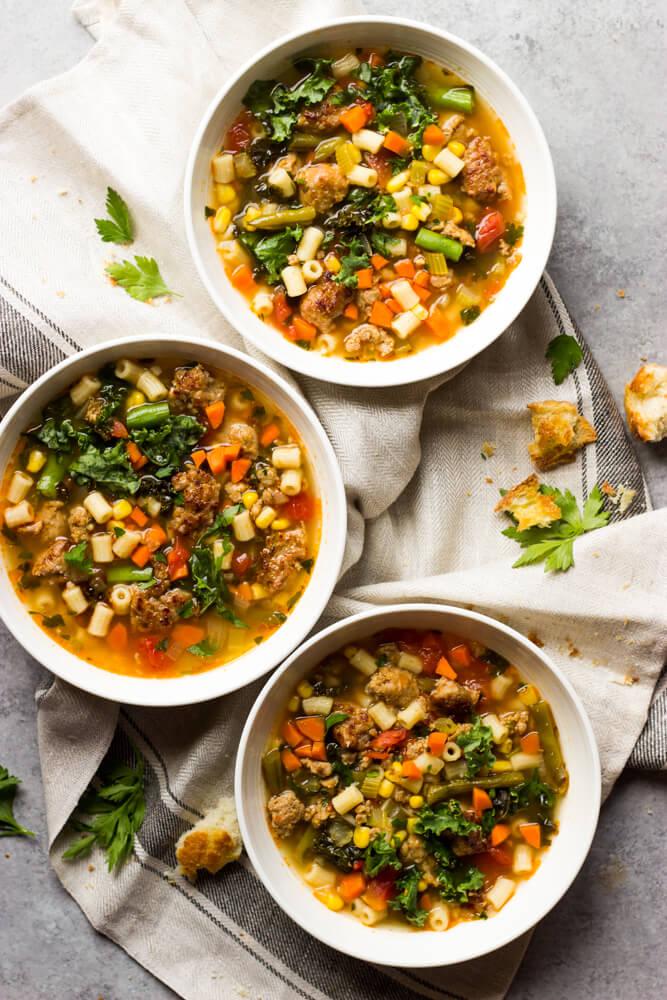 Italian sausage kale soup in white bowl