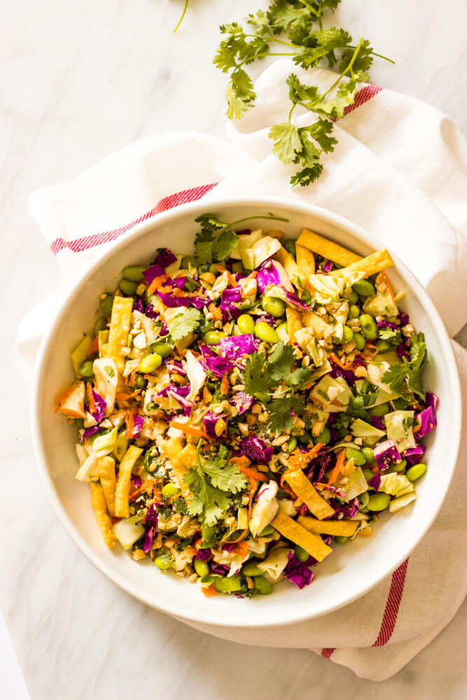 crunchy asian salad in a white bowl.