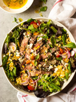 Steak salad in white bowl