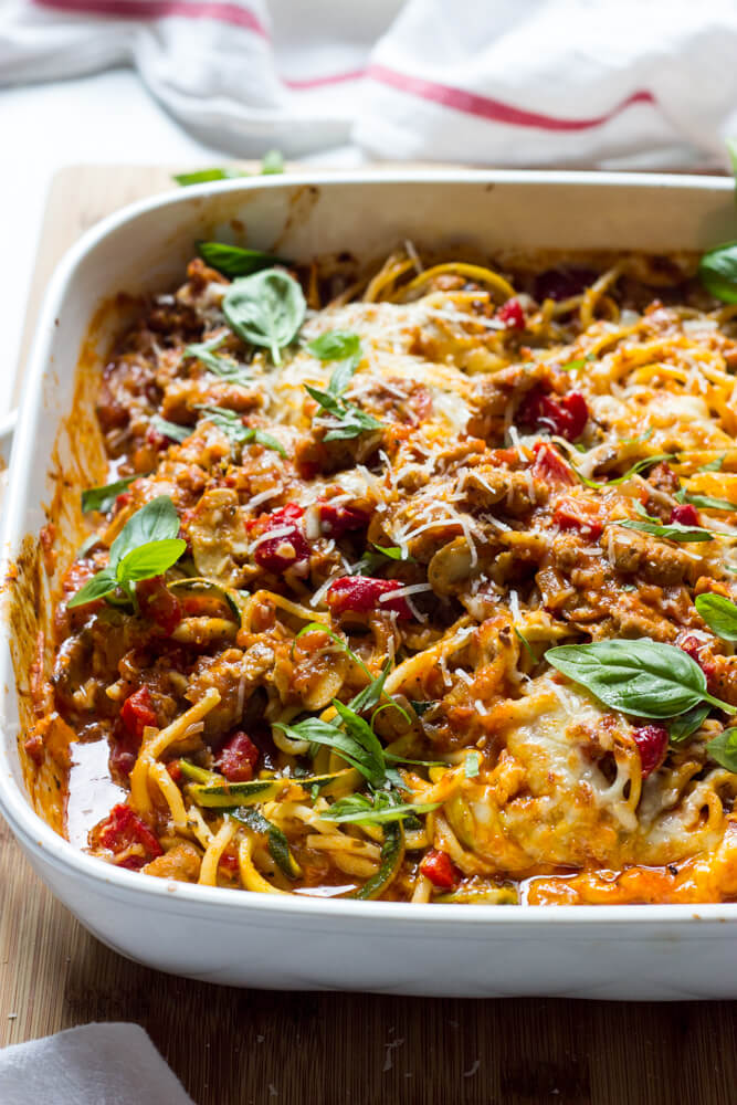 Side close-up of spaghetti zucchini bake in white casserole dish