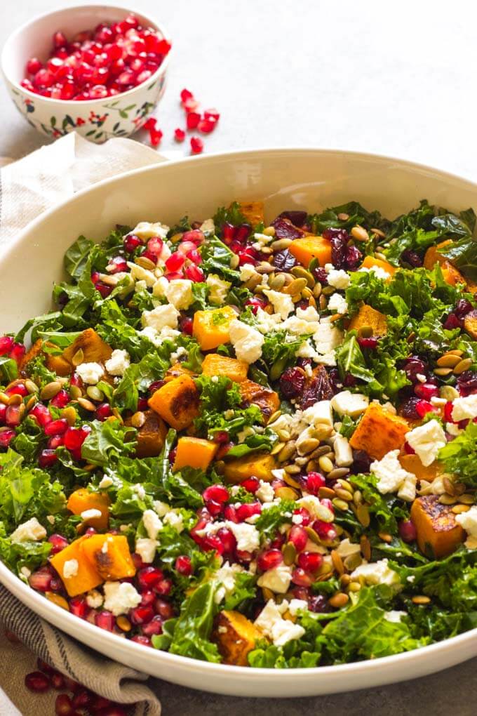 Close up side view of kale salad in white bowl