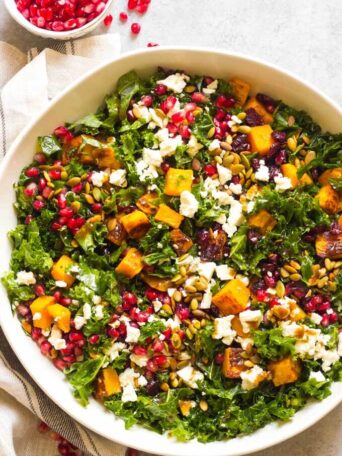 Close up of kale salad in white bowl