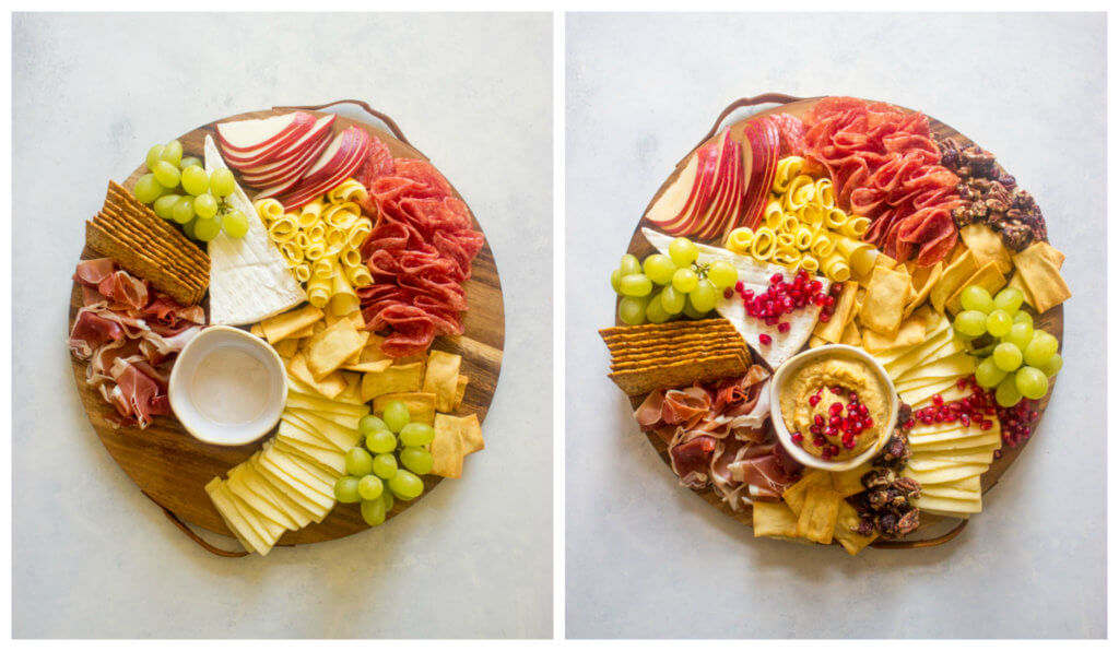 Sliced meat and cheese with fruit on a wooden board