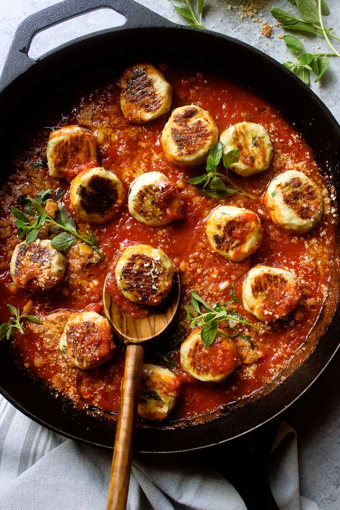 Close up of best chicken meatballs in marinara sauce in a cast-iron skillet