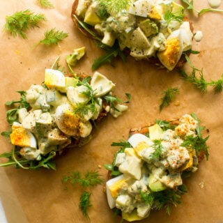 Egg salad served on toast with fresh herbs