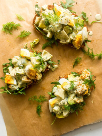 Egg salad served on toast with fresh herbs