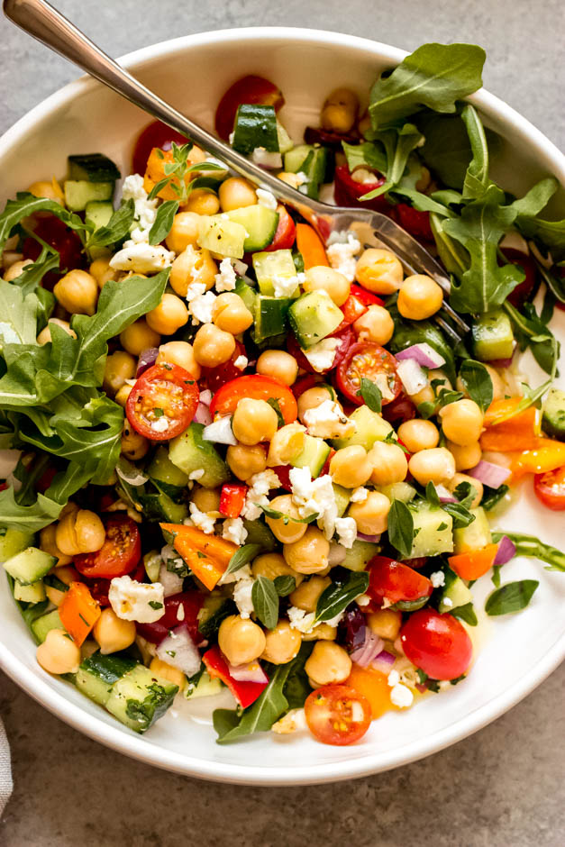 Close up greek chickpea salad in white bowl