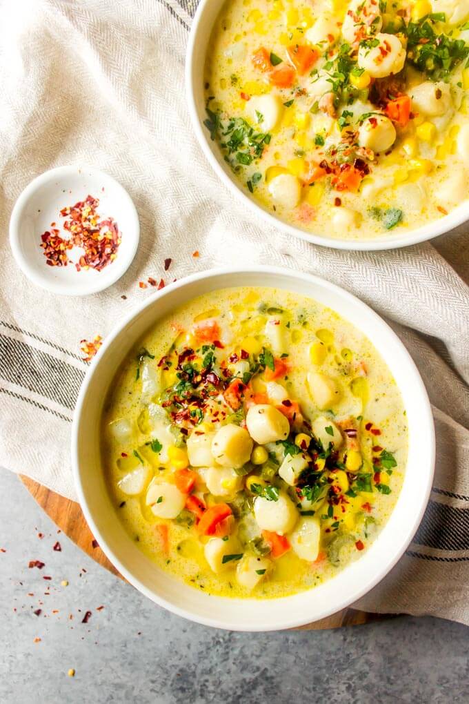 Overhead scallop chowder in white bowl