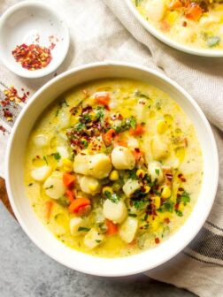 Close up of chowder recipe with scallops in white bowl