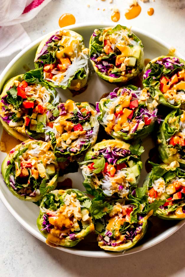 Close up of vegetable rice paper rolls in white serving platter