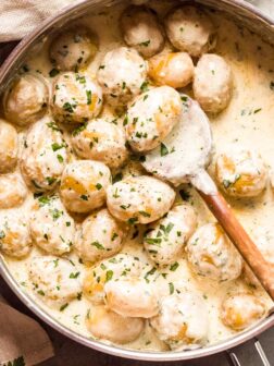 Overhead new potatoes in cream sauce in skillet