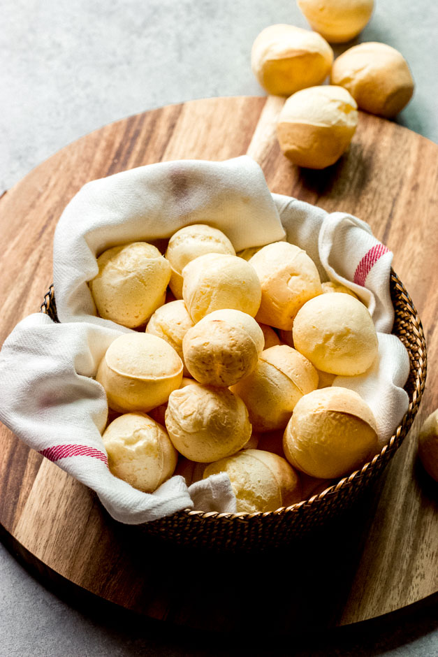 Gluten free cheese bread in basket on wooden board