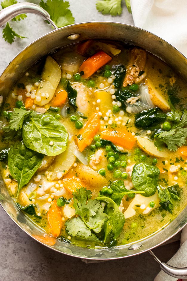 Close up chicken stew with potatoes and vegetables in dutch oven
