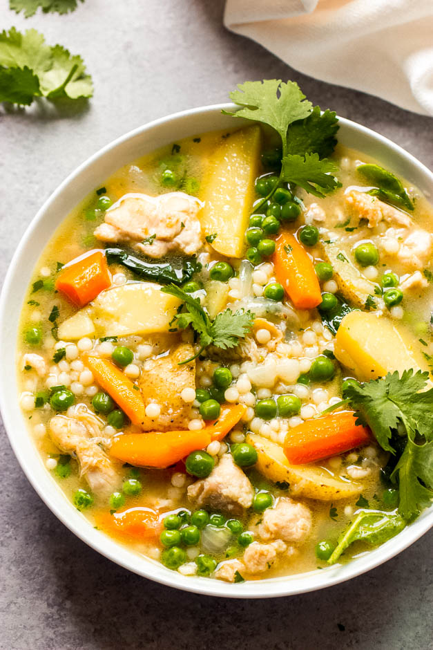 Overhead chicken vegetable stew in white bowl