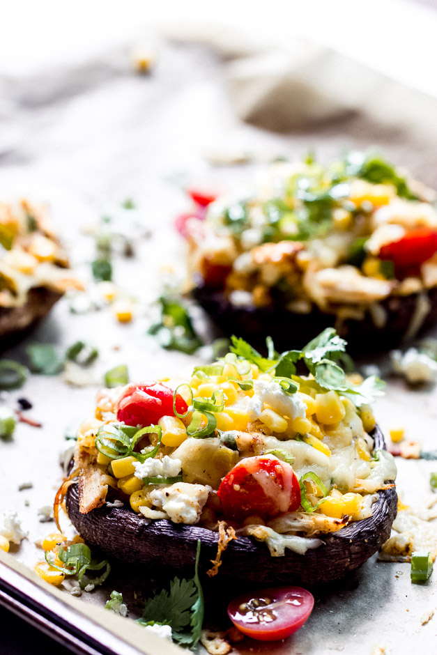 Side close up stuffed portobello caps with chicken, corn, and cheese.