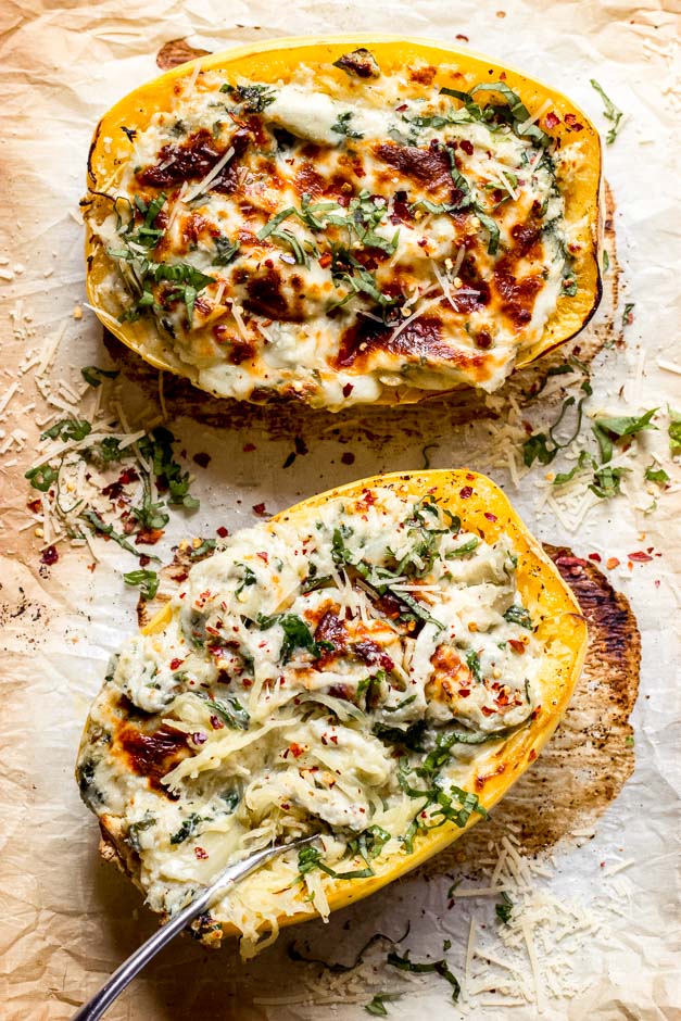 Overhead roasted spaghetti squash with cheese, artichokes, and spinach.