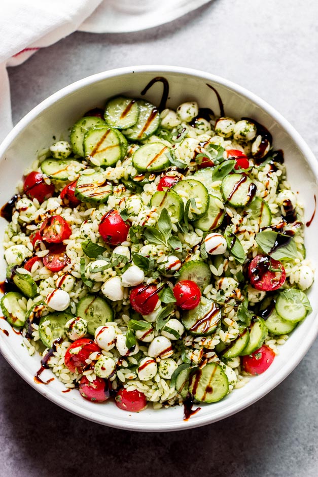 Pasta salad with orzo in white bowl