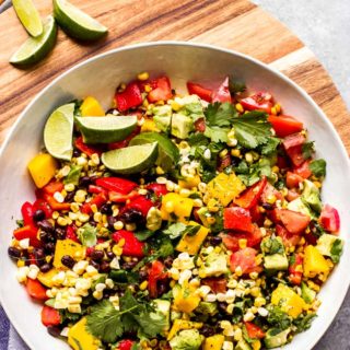 Overhead Mexican salad in white bowl on board