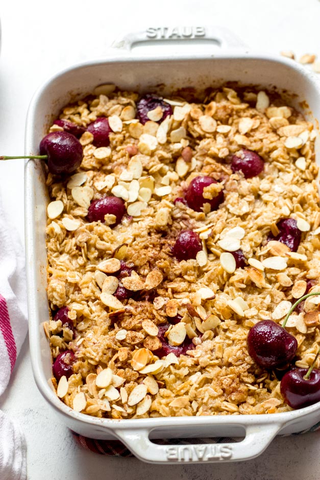 Oatmeal bake with cherries in white casserole