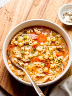 italian chicken noodle soup in white bowl