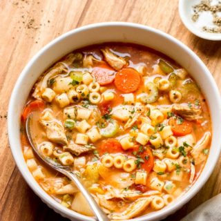 italian chicken noodle soup in white bowl