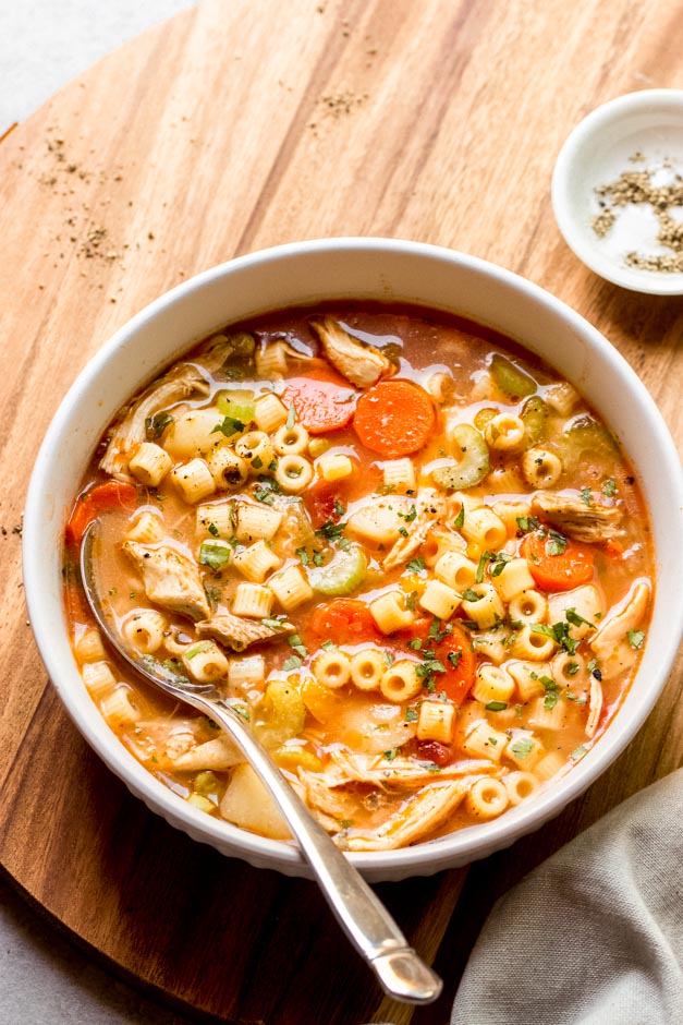 italian chicken noodle soup in white bowl