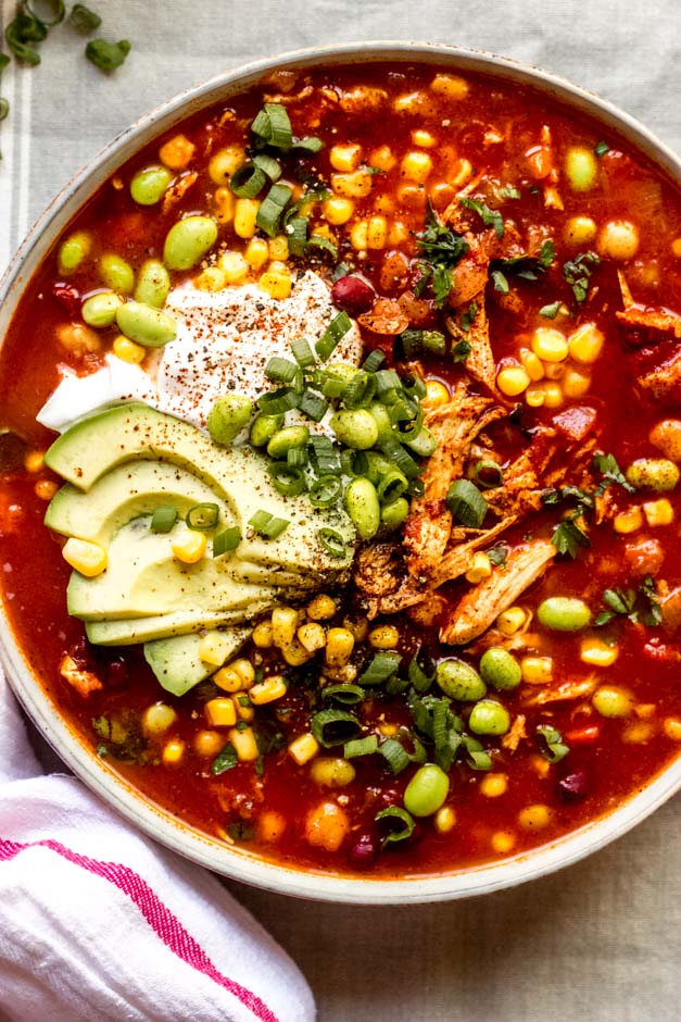 close up turkey chili recipe in a bowl with toppings.