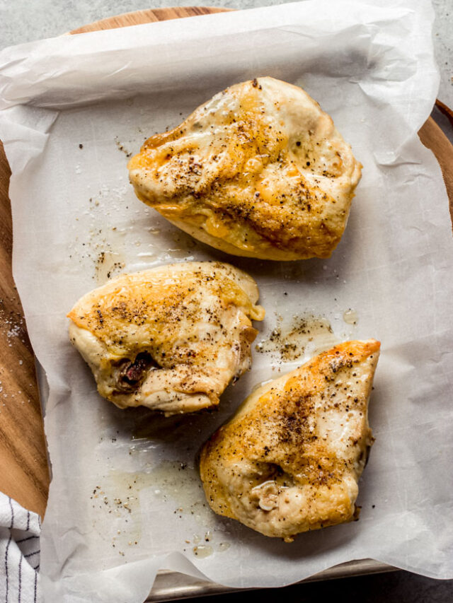 bone in chicken breast on a baking sheet.