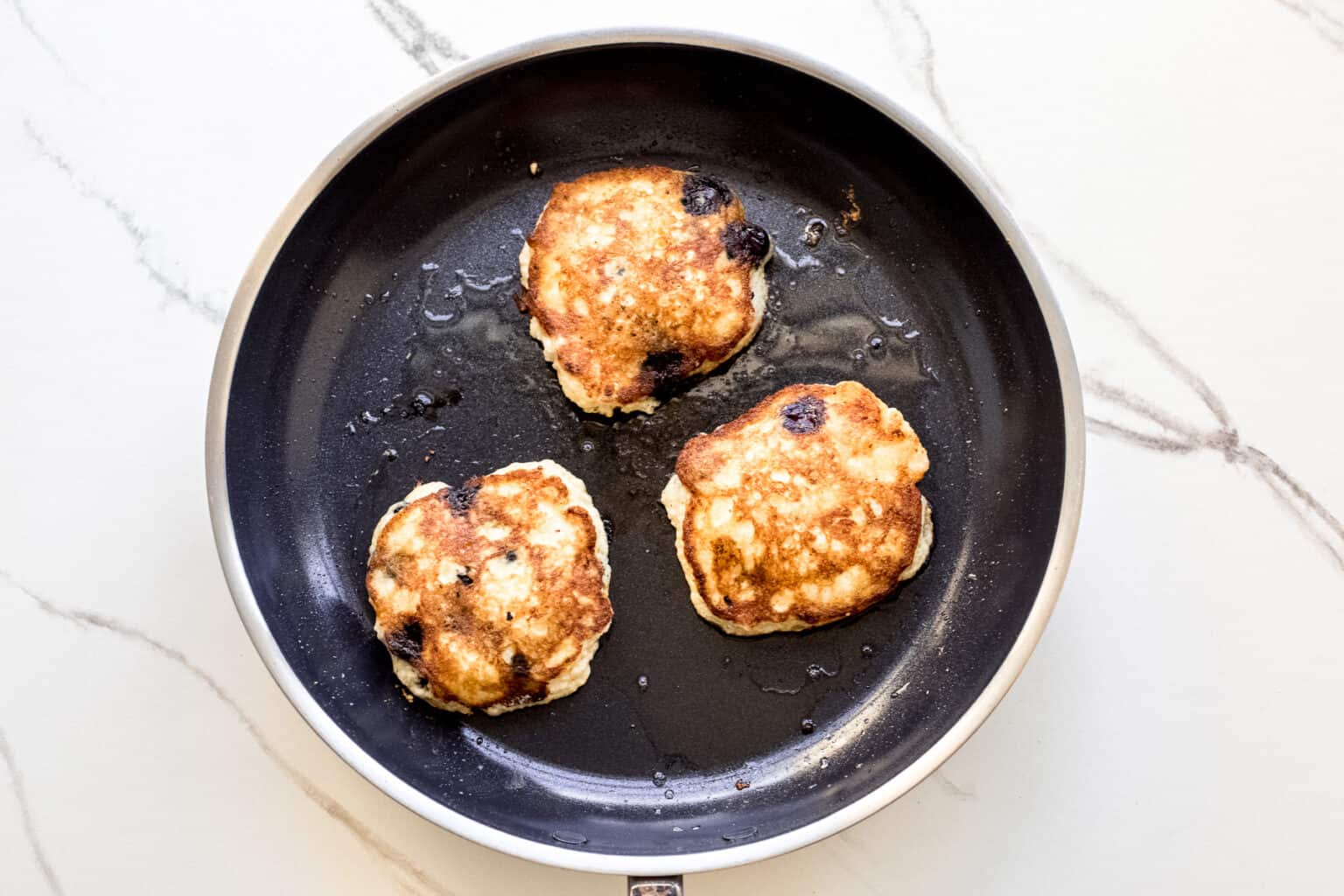 cooked ricotta pancakes in a skillet